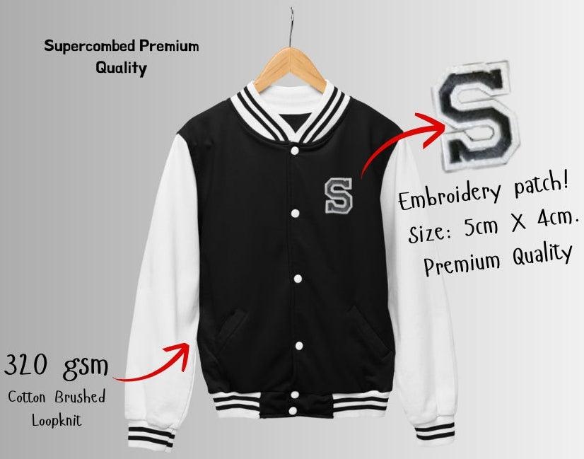 Black and white varsity jacket with embroidery patch on a gray background