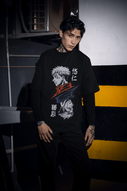 Person wearing a black hoodie with a graphic design in an urban setting